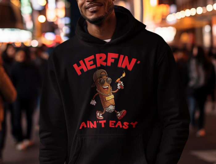 Person wearing a black hoodie with a graphic design hoodie with Herfin' Ain't Easy and a cigar on it.